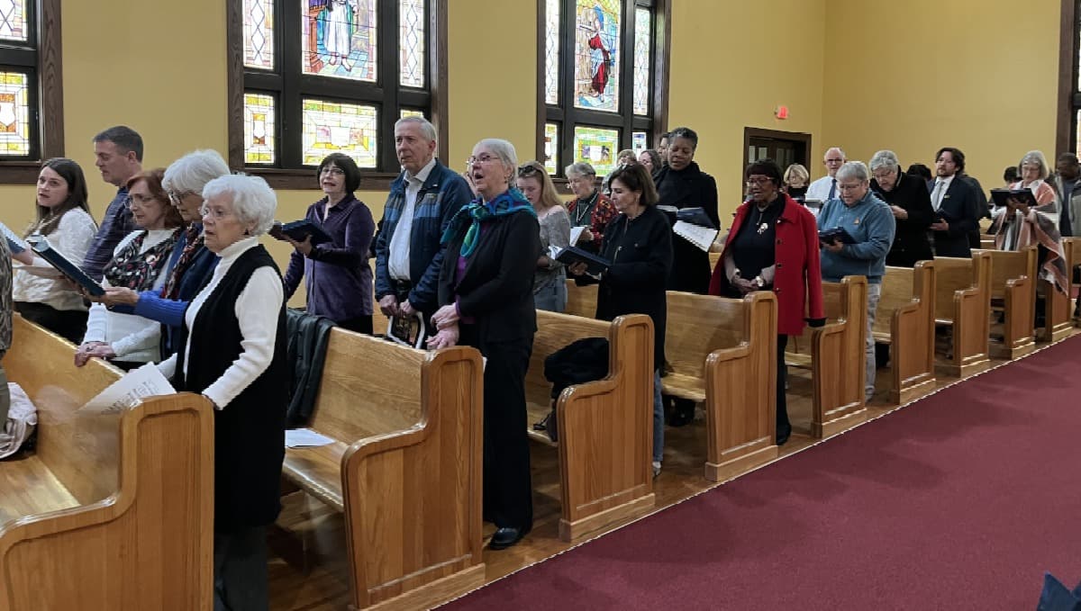 Congregation standing and singing during Sunday worship service